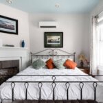 King size wrought iron bed and a stately fireplace set the tone