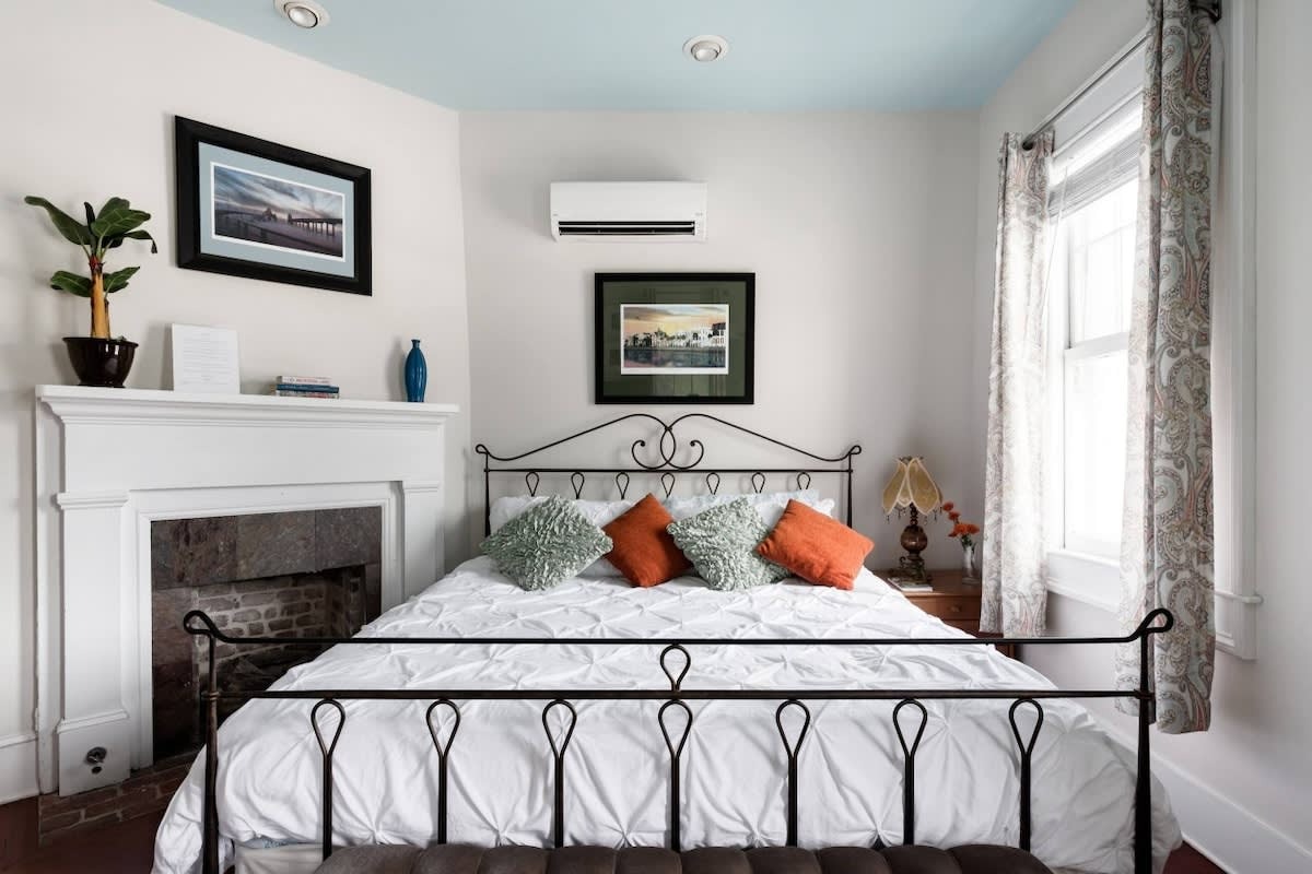 King size wrought iron bed and a stately fireplace set the tone